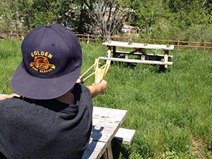 child with slingshot