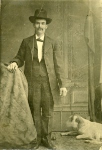 historic photograph of Adam Reynolds posing with a dog