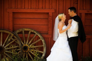 bride and groom standing in front of blacksmith shop