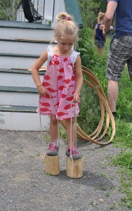 child playing historic stilt game