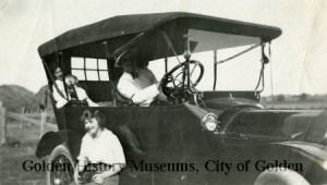 historic automobile with three people