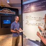 two visitors viewing museum exhibit