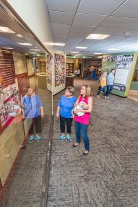 several guests viewing history museum exhibits