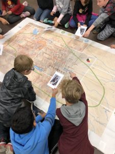 children looking at a giant map of Colorado